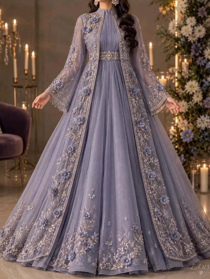 Lavish floor-length gown with heavy neckline embroidery and ruffled hemline.